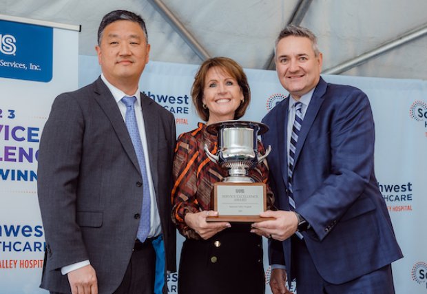 Edward Sim and Marc Miller presenting the Service Excellence Award to Darlene Wetton