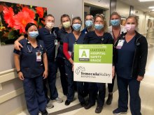 ICU Team Holding Leapfrog A Grade Sign