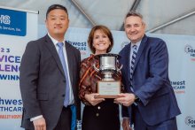 Edward Sim and Marc Miller presenting the Service Excellence Award to Darlene Wetton